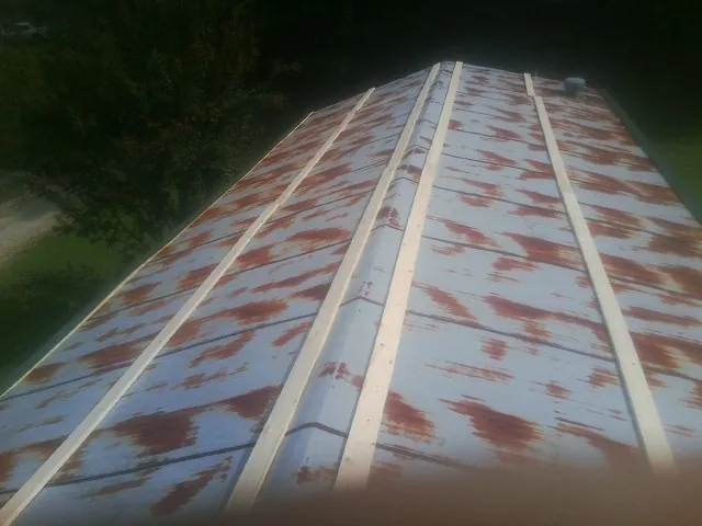 Rusted metal roof panels with new wood purlins before replacement — Storm Damage Roof Repair in South Fallsburg by Roofing Brothers