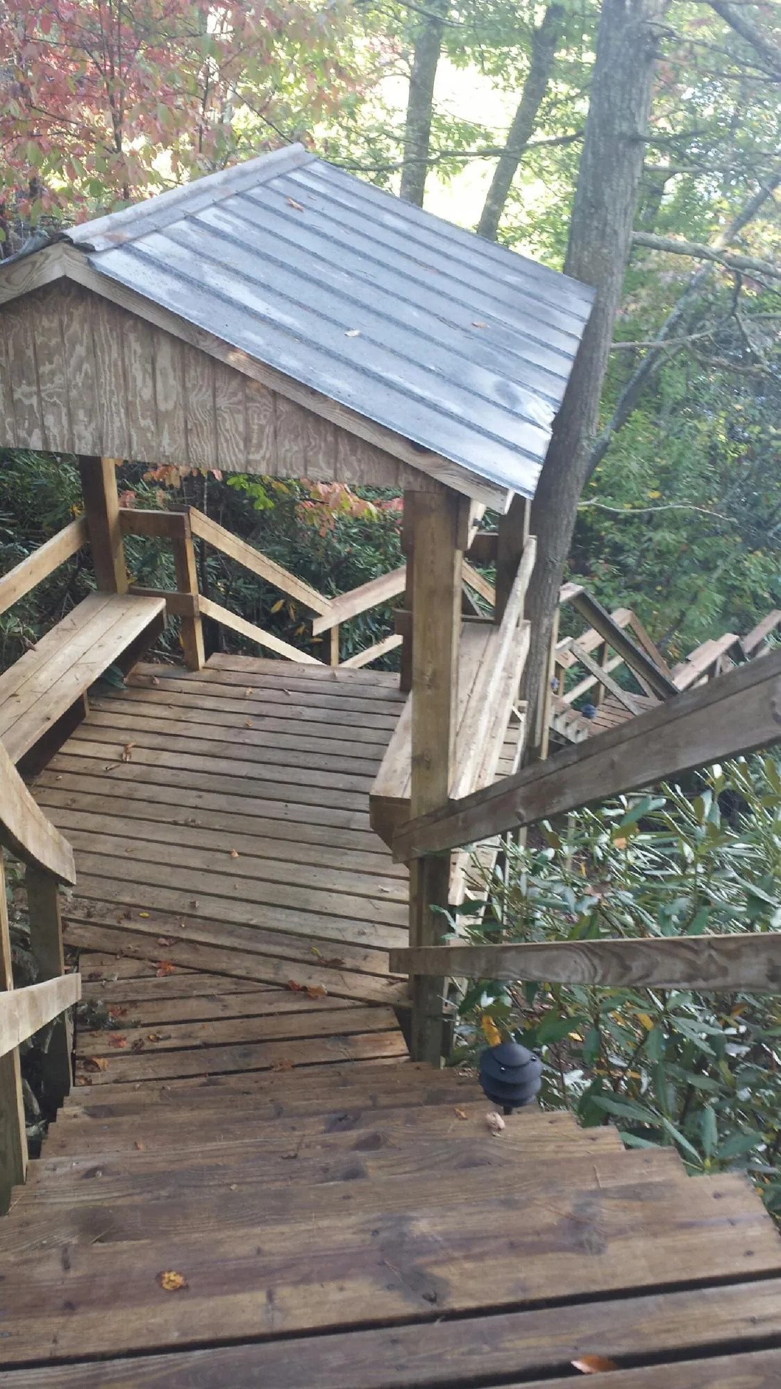 Metal roofed shelter over wooden steps on a wooded walkway — Skylight Repair & Installation work by our crew in South Fallsburg