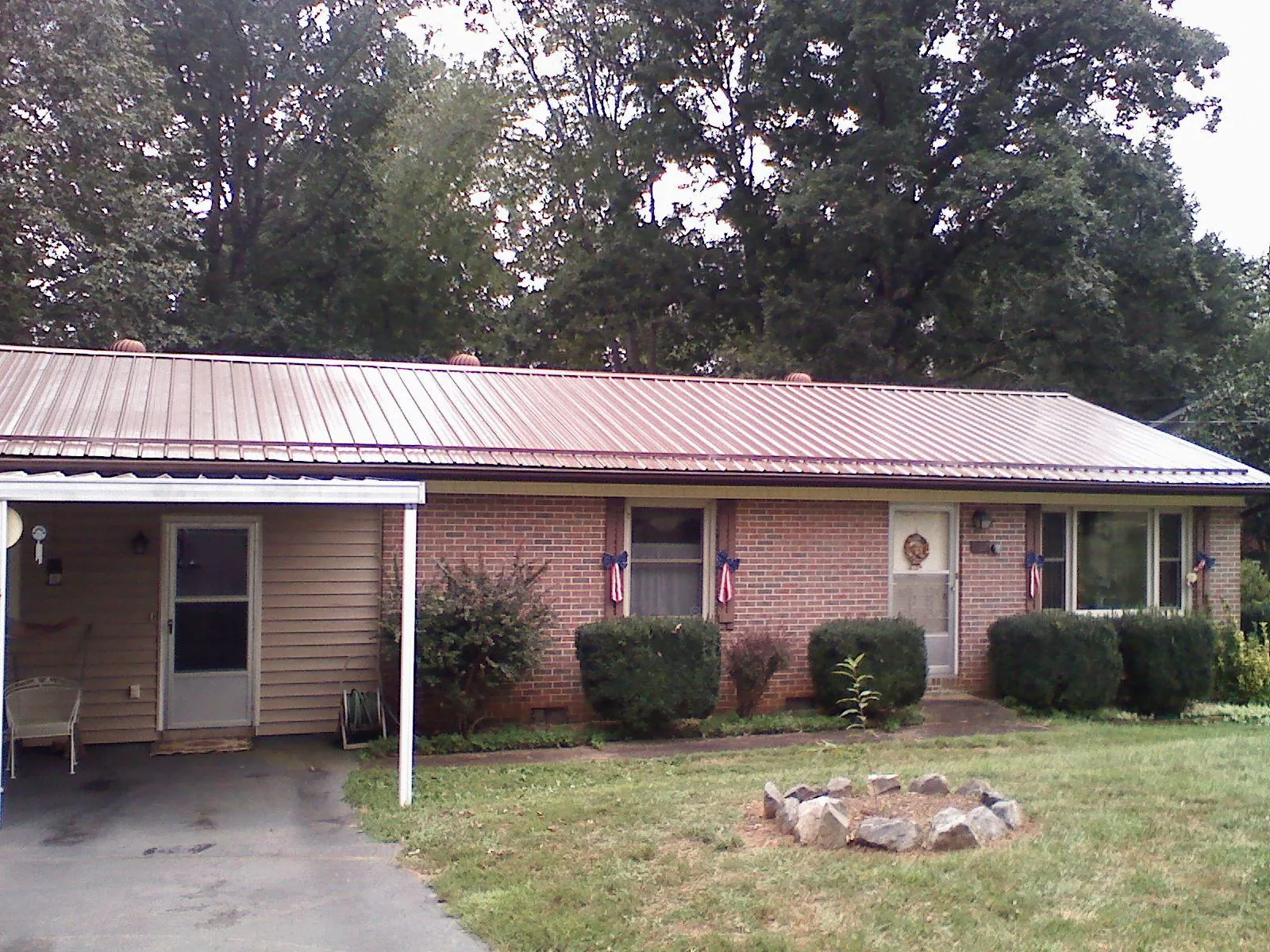 Bronze metal roof and carport on a brick ranch home — Roof Repair work by our crew in South Fallsburg