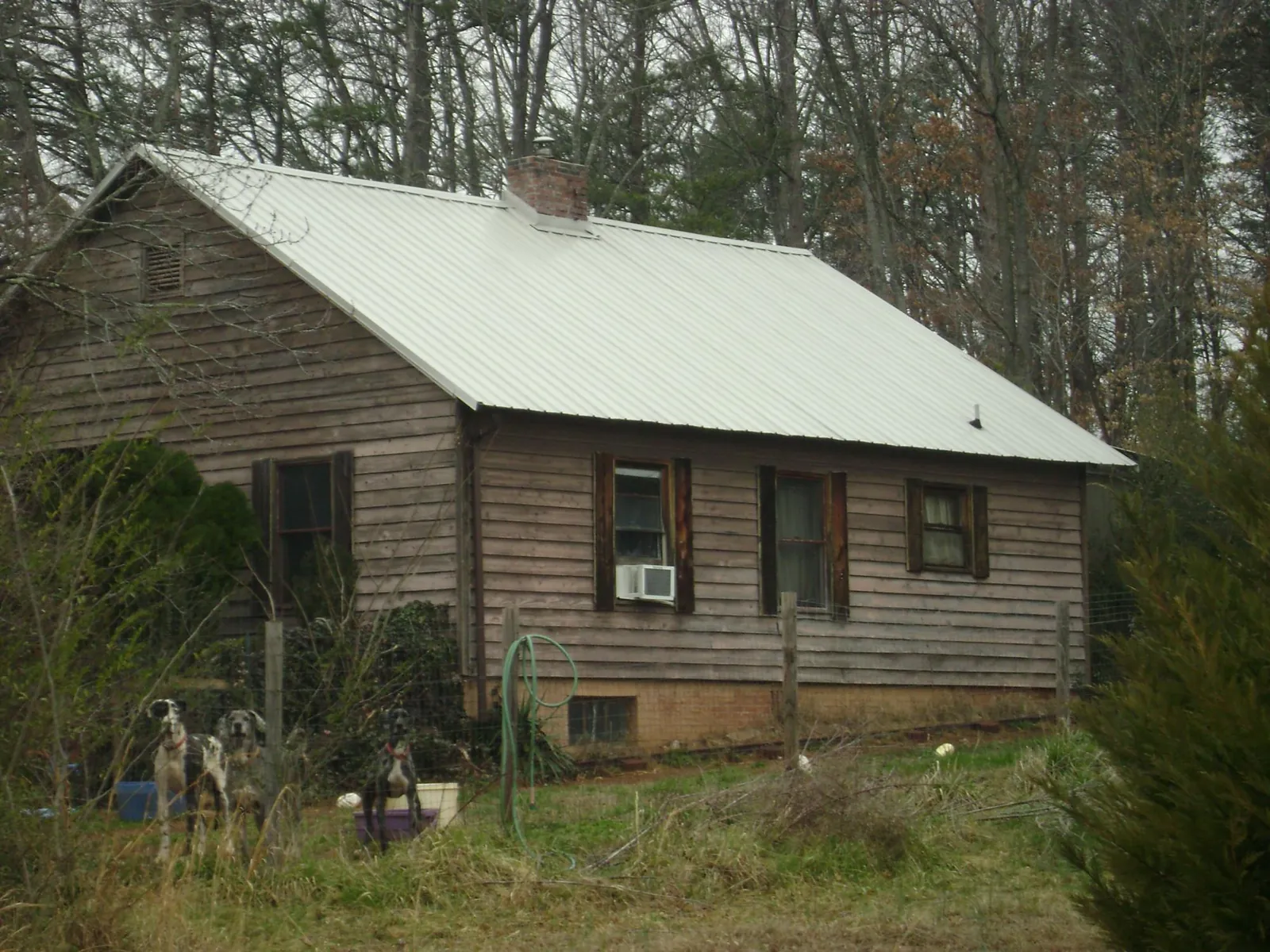 White metal roof on an old wood sided farmhouse, from a Metal Roof Installation job in South Fallsburg